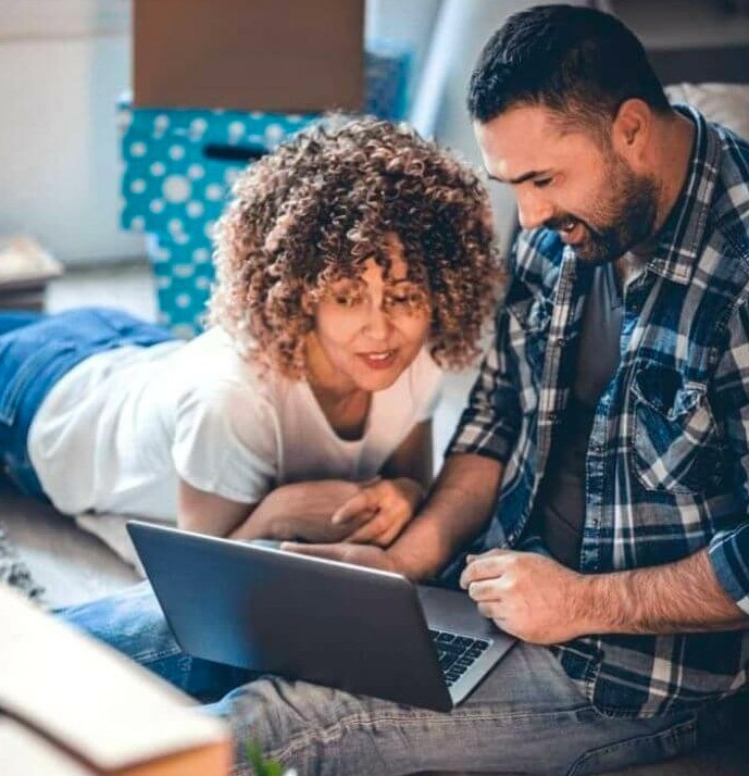 Two persons looking at a laptop